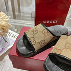 Gucci slide sandals with tan GG canvas bands and black open-toe footbeds