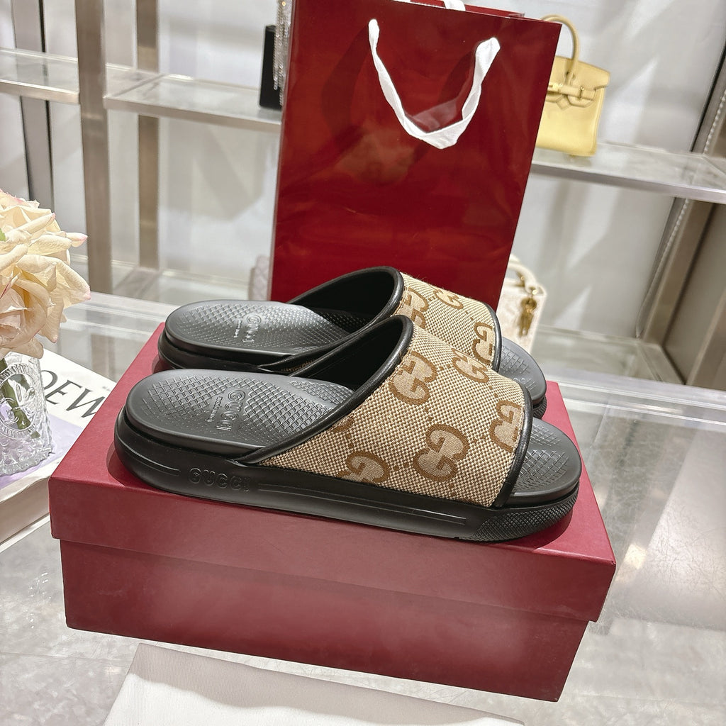 Gucci slide sandals, tan GG logo upper with black footbed and strap