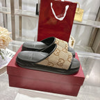 Gucci slide sandals, tan GG logo upper with black footbed and strap