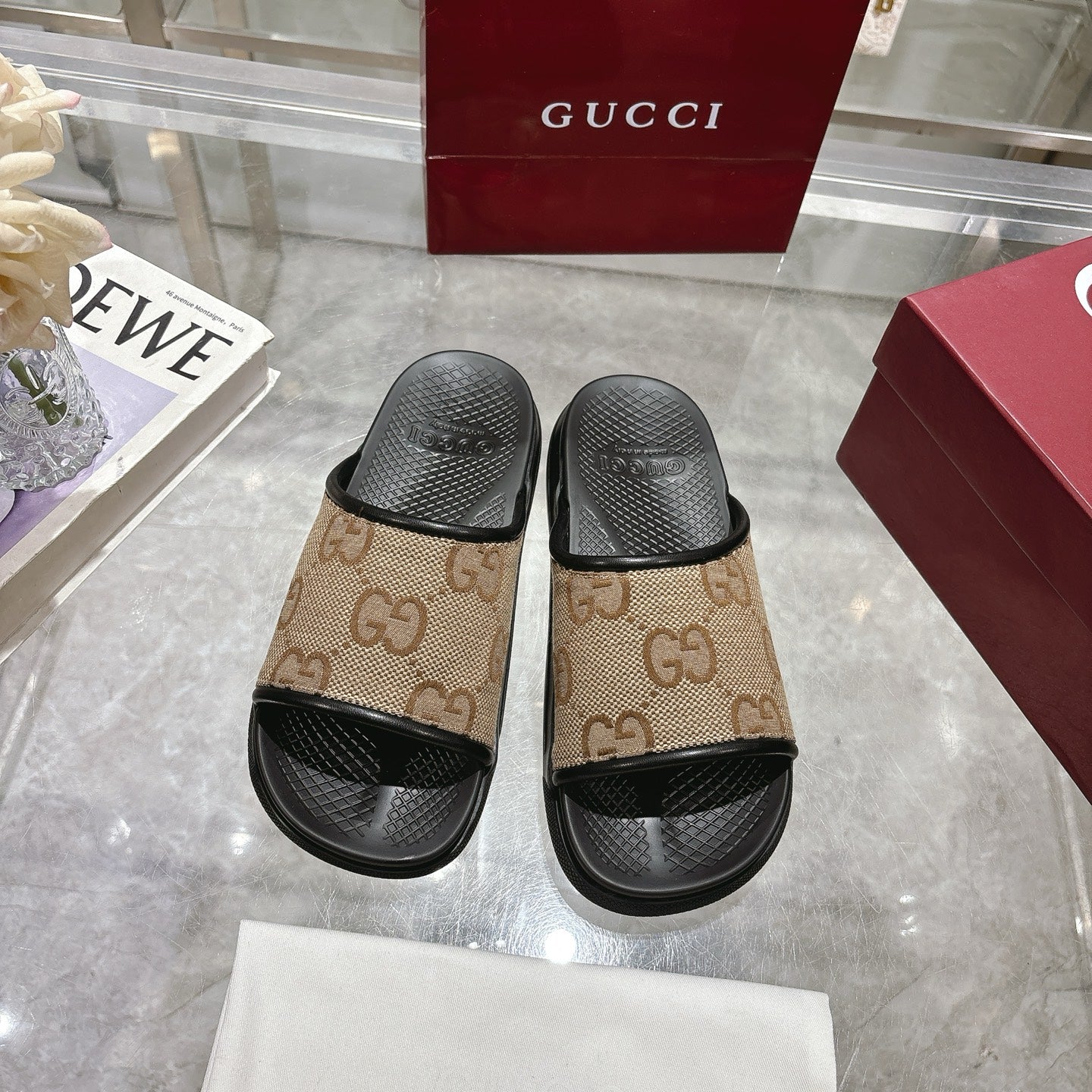 Gucci slide sandals pair with tan GG monogram straps and black open-toe footbeds