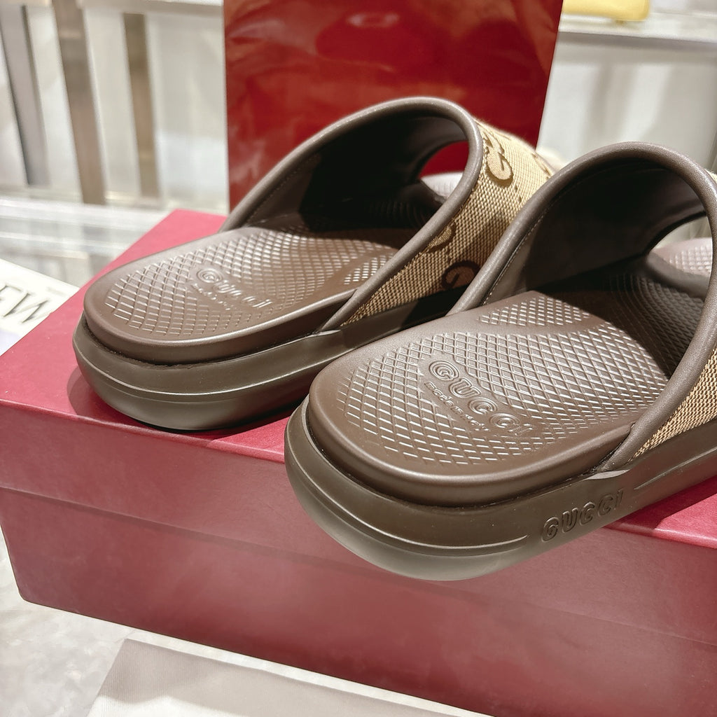 Beige GG canvas slide sandals with dark footbeds, top view