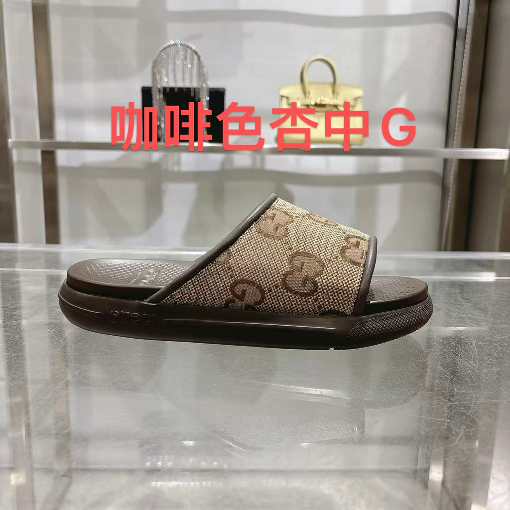 Beige GG canvas slide sandals with dark rubber sole, cushioned footbed