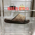 Beige GG canvas slide sandals with dark rubber sole, cushioned footbed