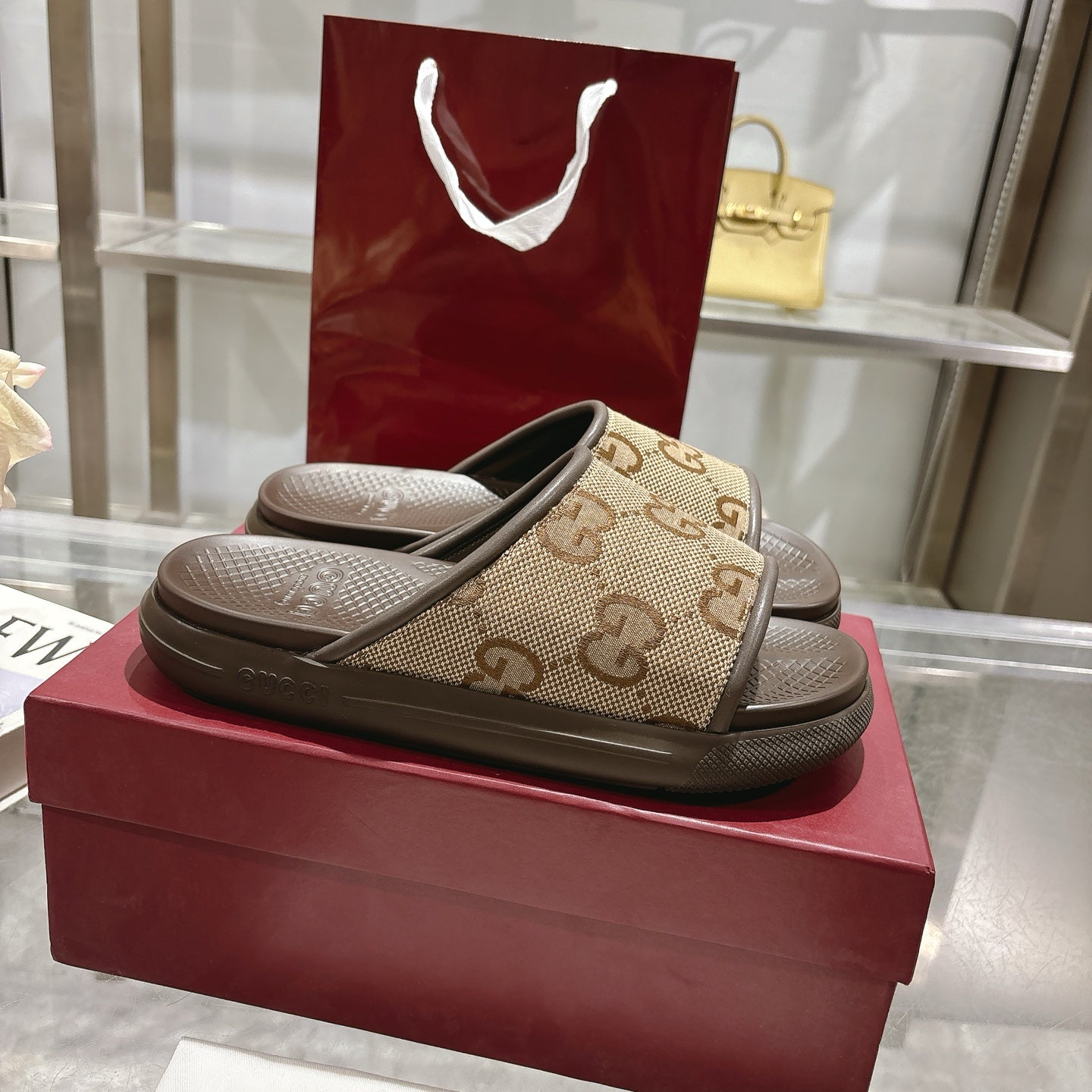 Beige GG canvas slide sandals with dark sole, cushioned footbed, pair view