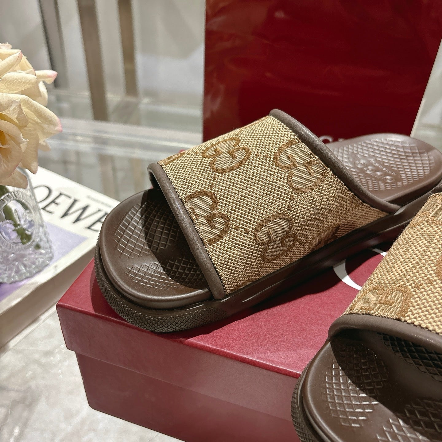 Beige GG canvas slide sandals with dark sole, close side view