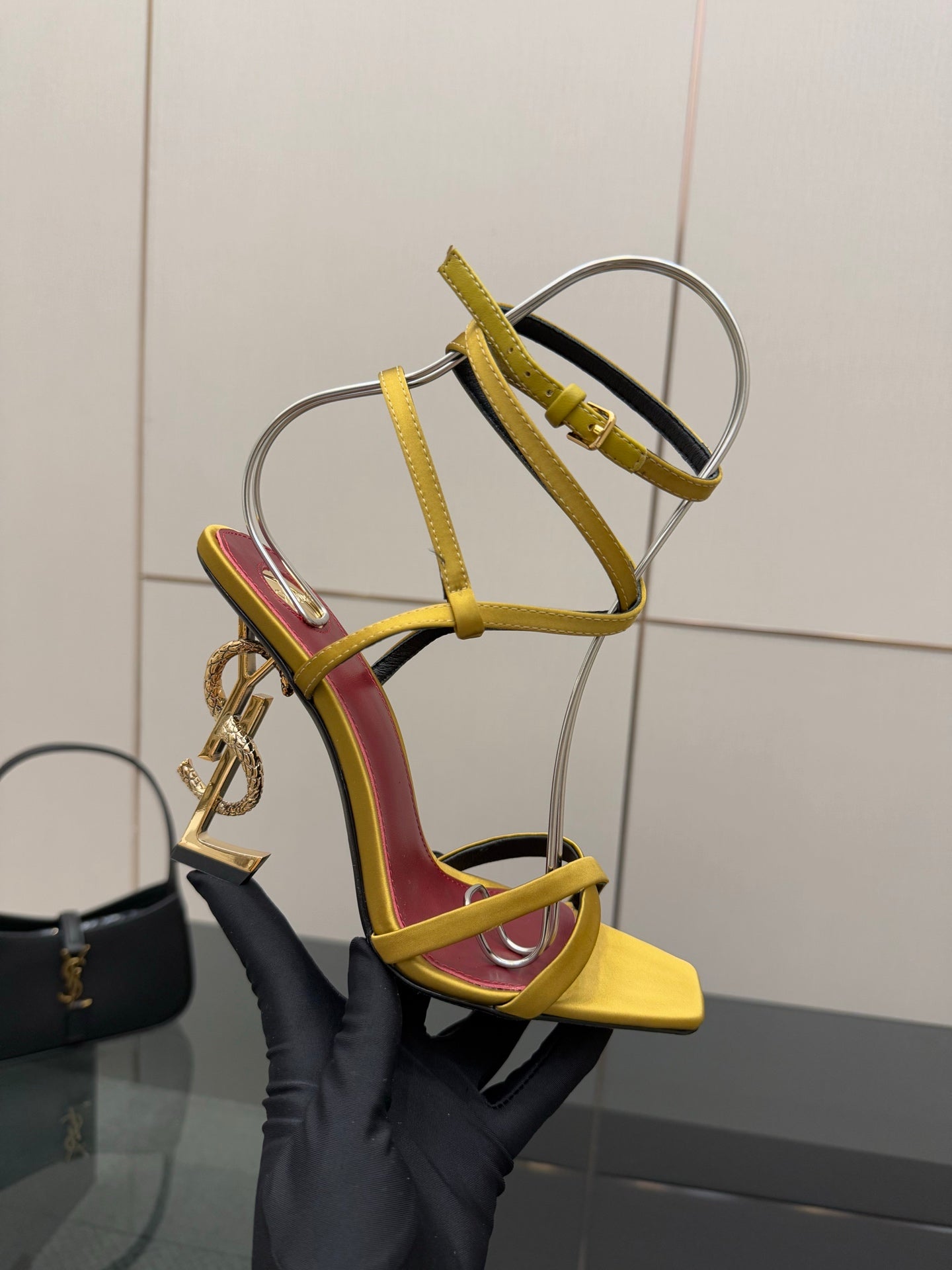 YSL heeled sandals close-up, yellow cage straps, red lining, gold-tone buckle, open toe