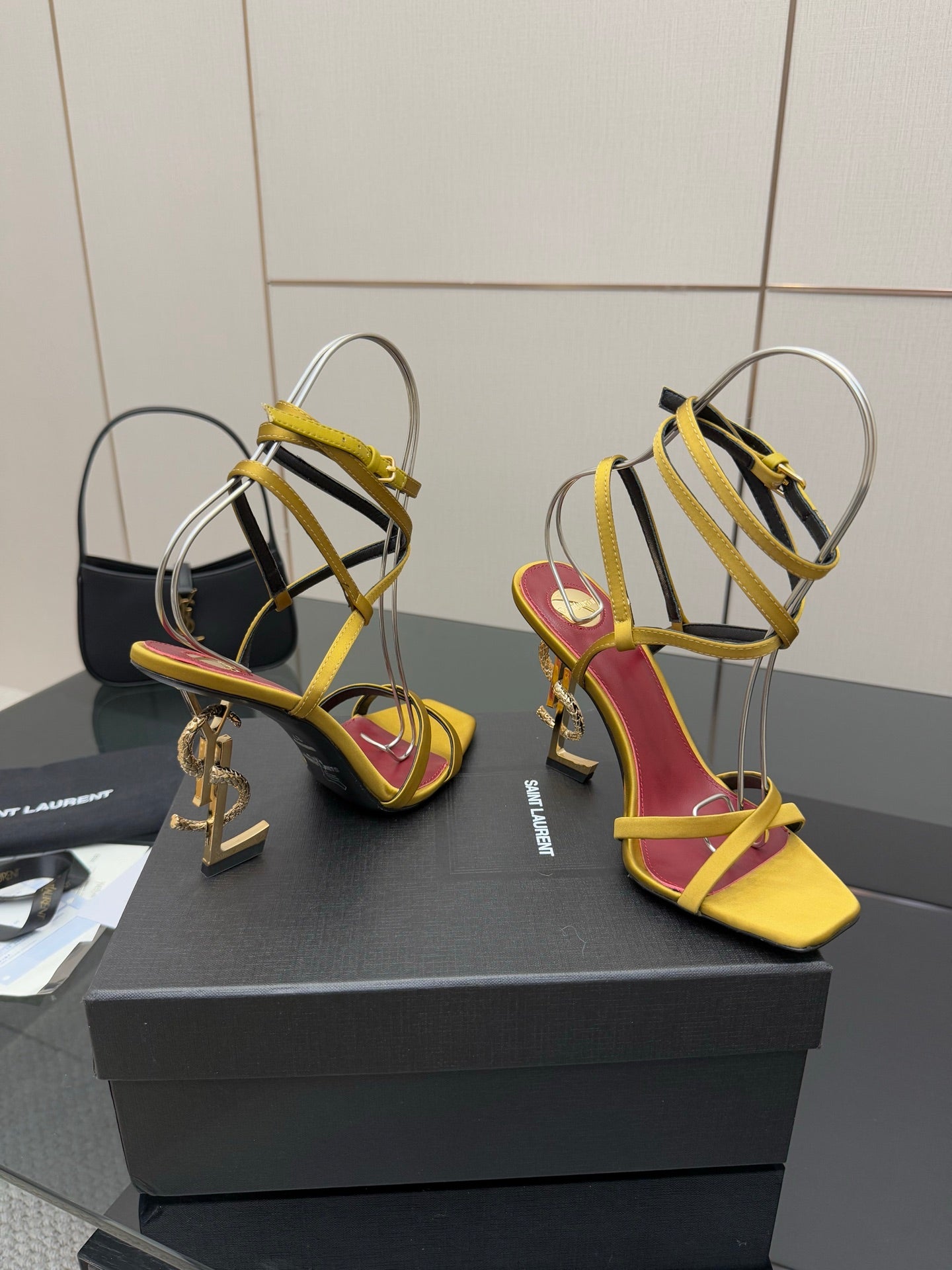 YSL heeled sandals on display, yellow straps and red lining, open toe, gold hardware