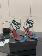 YSL ladies’ strappy heeled sandals on display, blue with red trim and gold accents