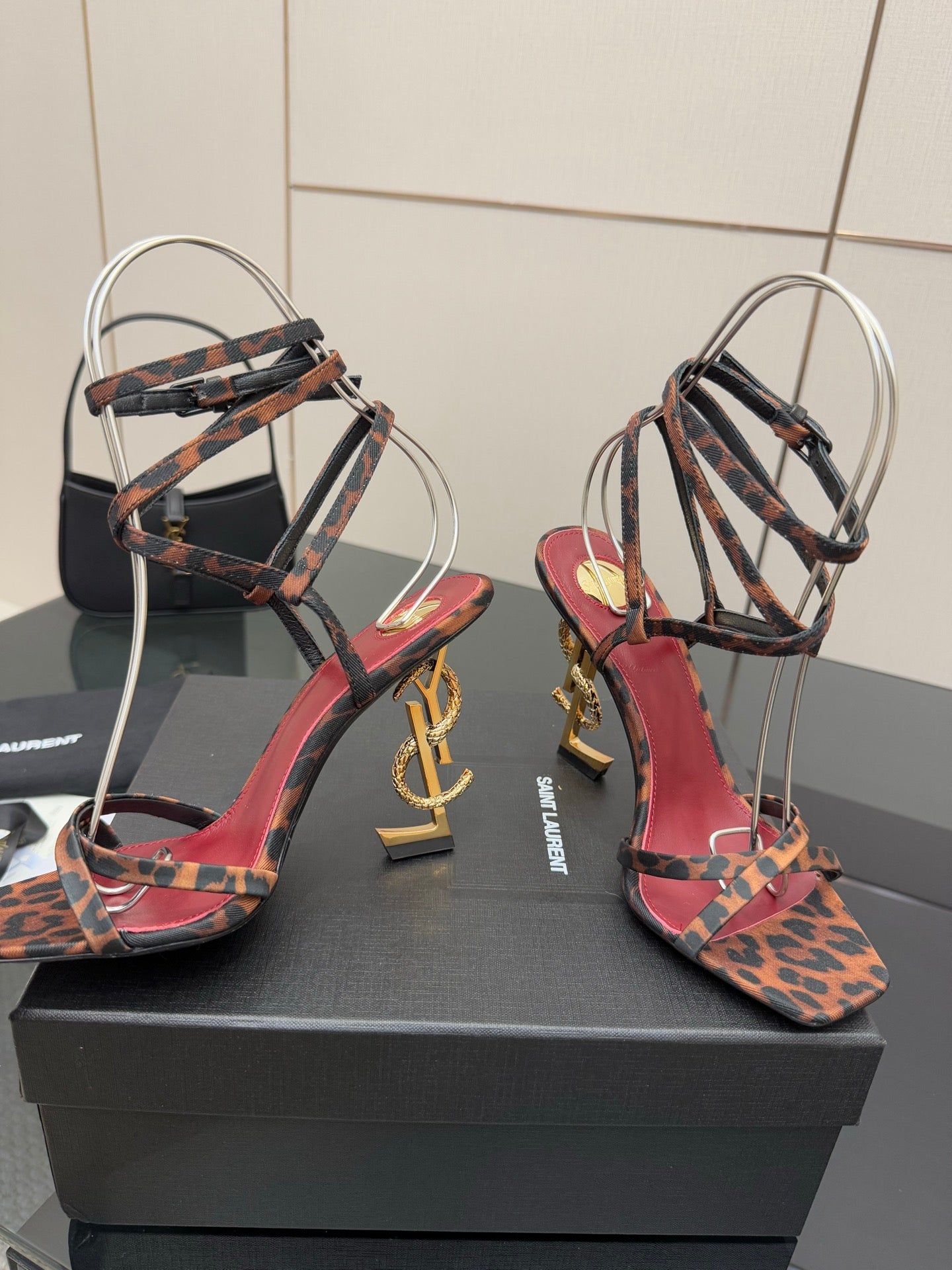 Leopard print strappy high-heel sandals with red/pink straps and gold logo heel