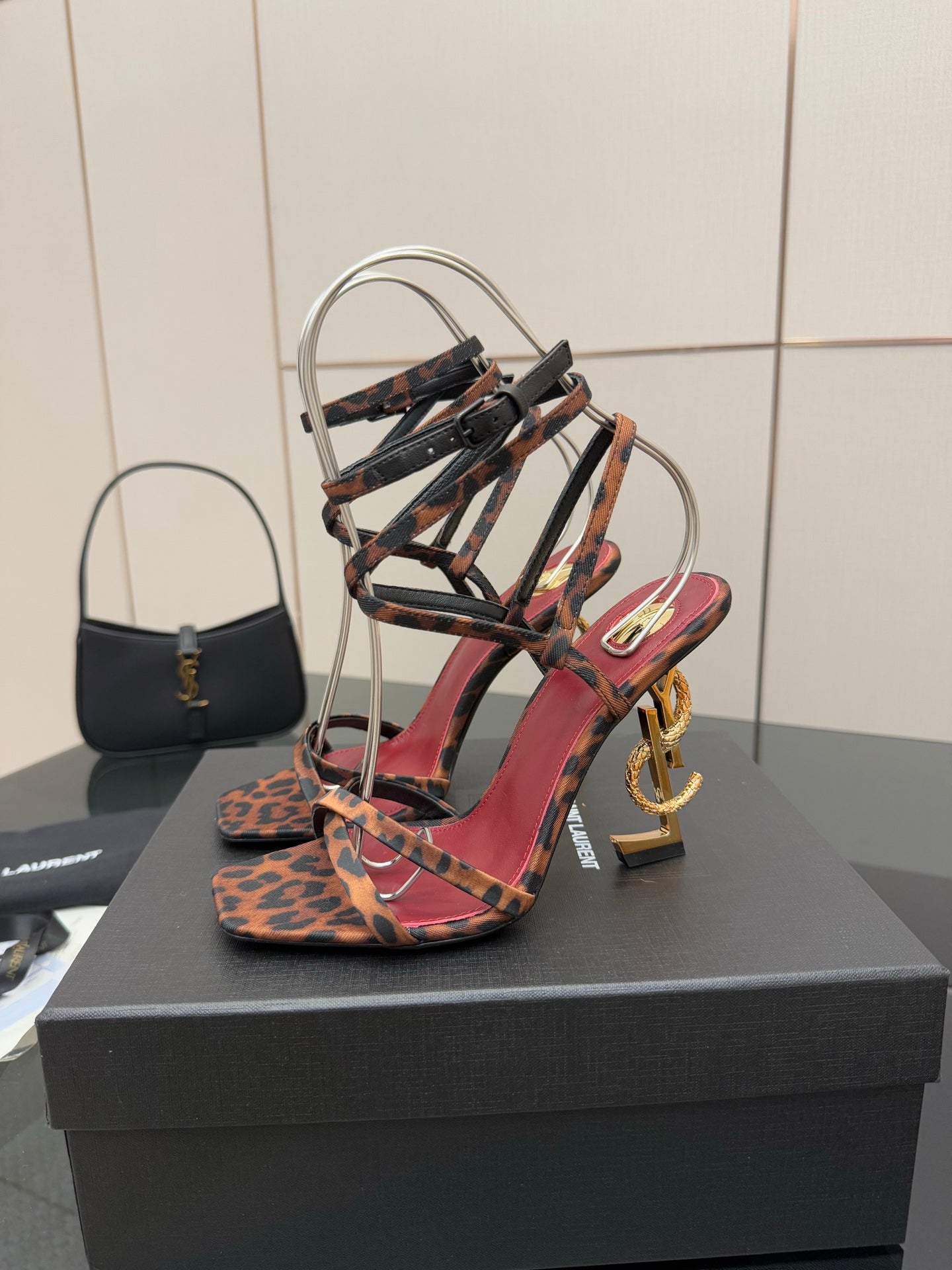 Leopard print strappy high-heel sandal, red and black straps, gold logo heel