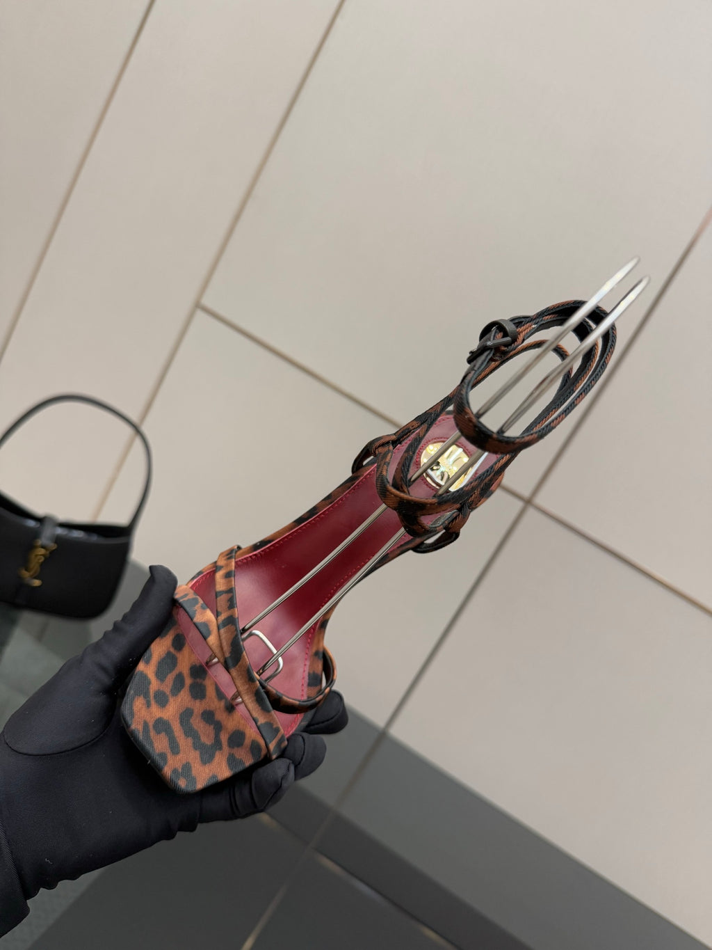 Leopard print sandal with red/pink straps and black harness, gold heel accent