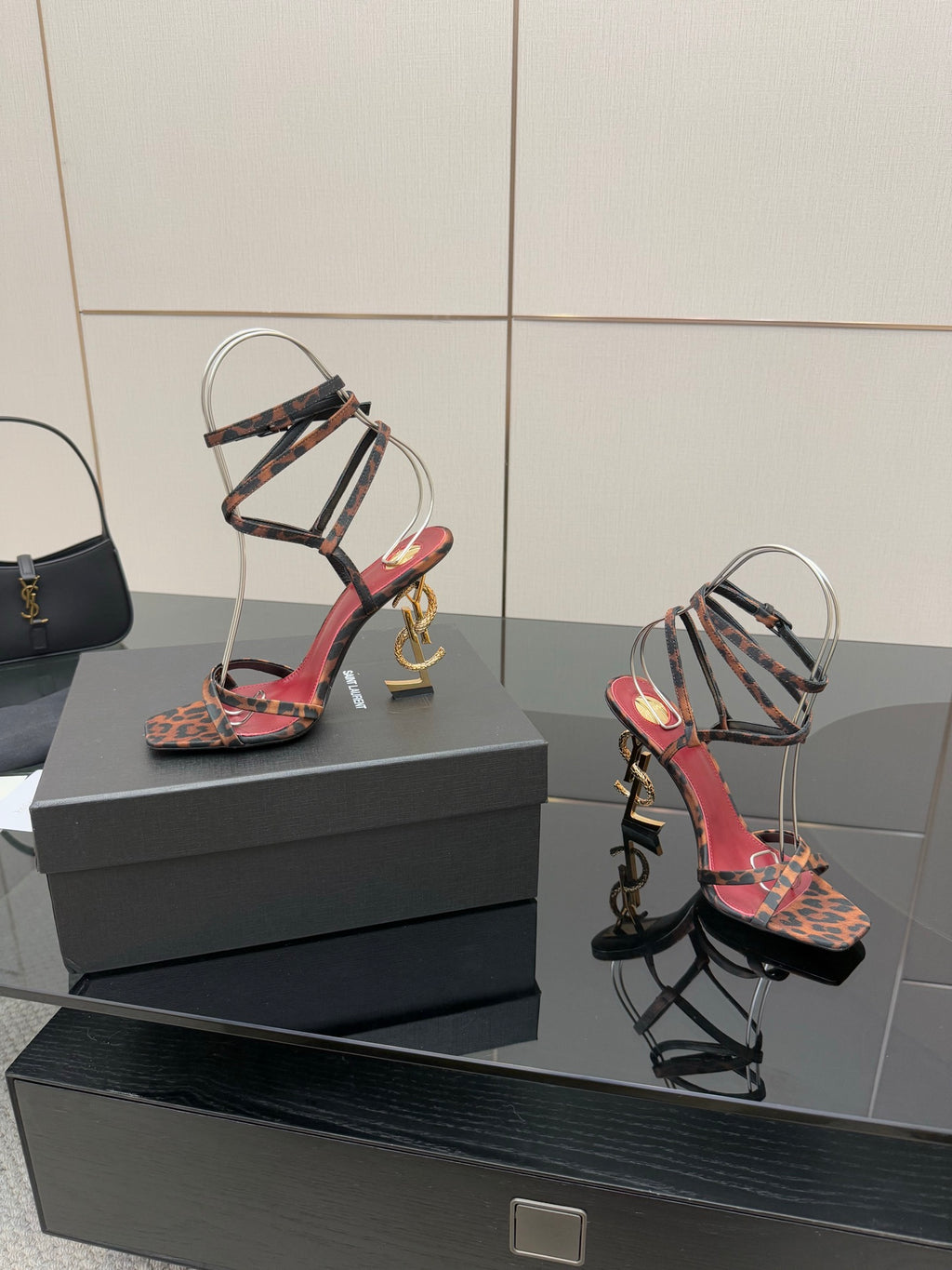 Leopard print strappy high-heel sandals with metal cage straps and gold logo heel