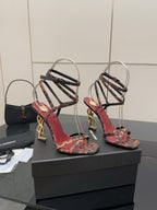 Leopard print strappy high-heel sandals with gold logo heels and black ankle straps