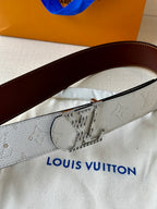 Louis Vuitton belt close-up: embossed gray strap with metal buckle and keeper detail