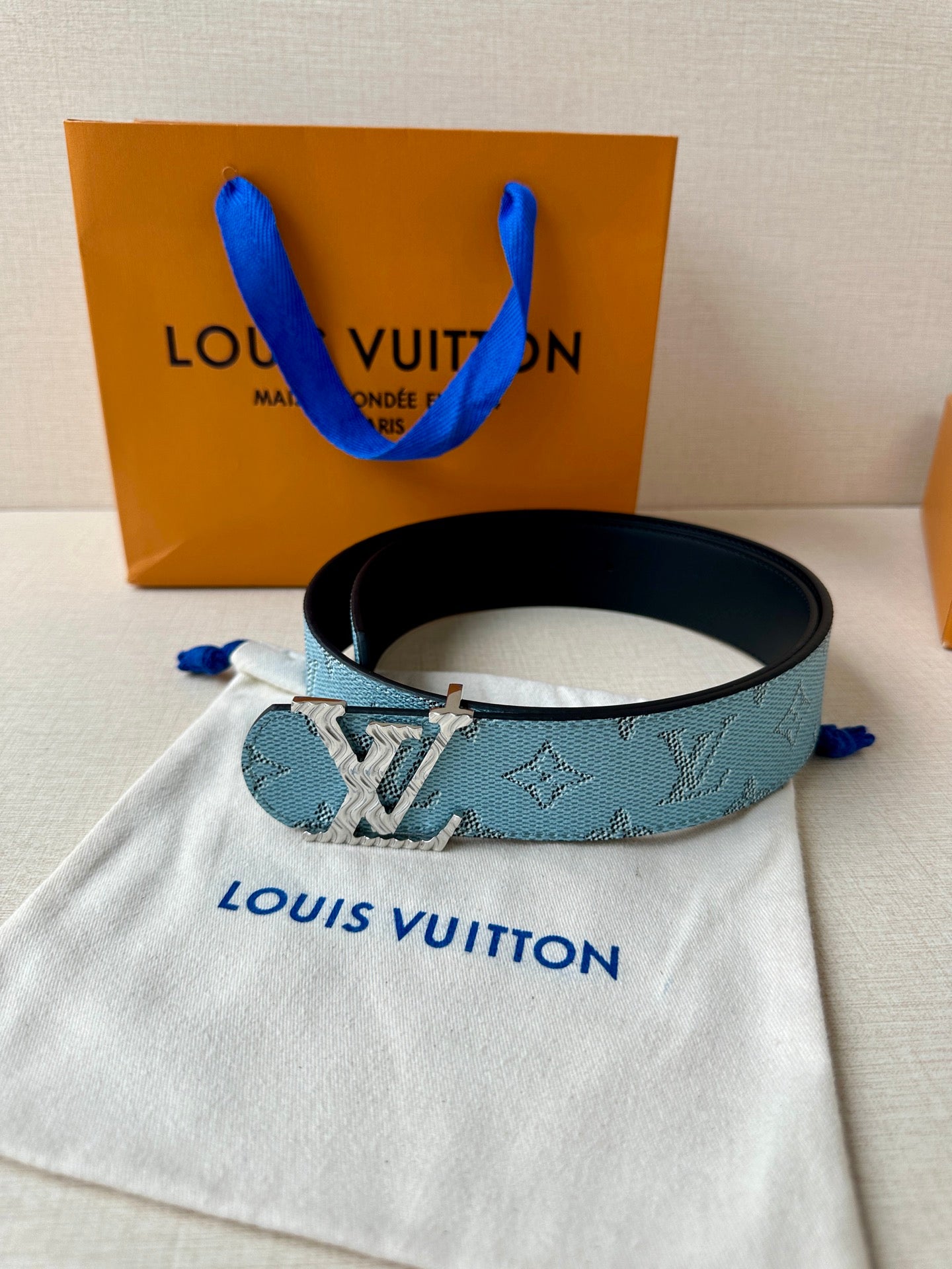 Blue monogram belt with gold buckle on black strap, with dust bag.