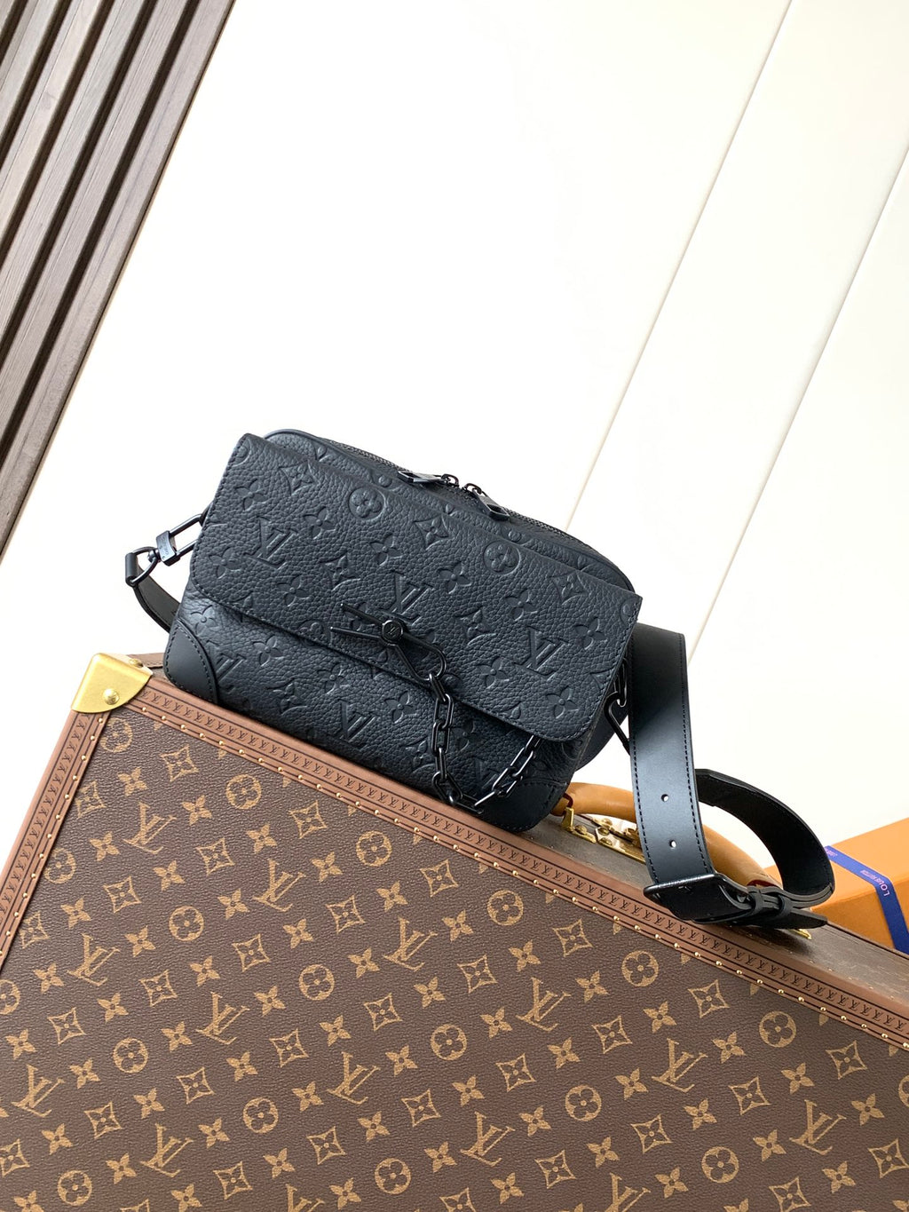 Dark monogram leather crossbody bag with flap and adjustable shoulder strap