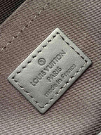 Leather luggage tag patch with stitched edges and printed Louis Vuitton wording