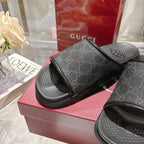 Monogram slide sandals with dark GG-pattern strap and contoured textured black footbeds