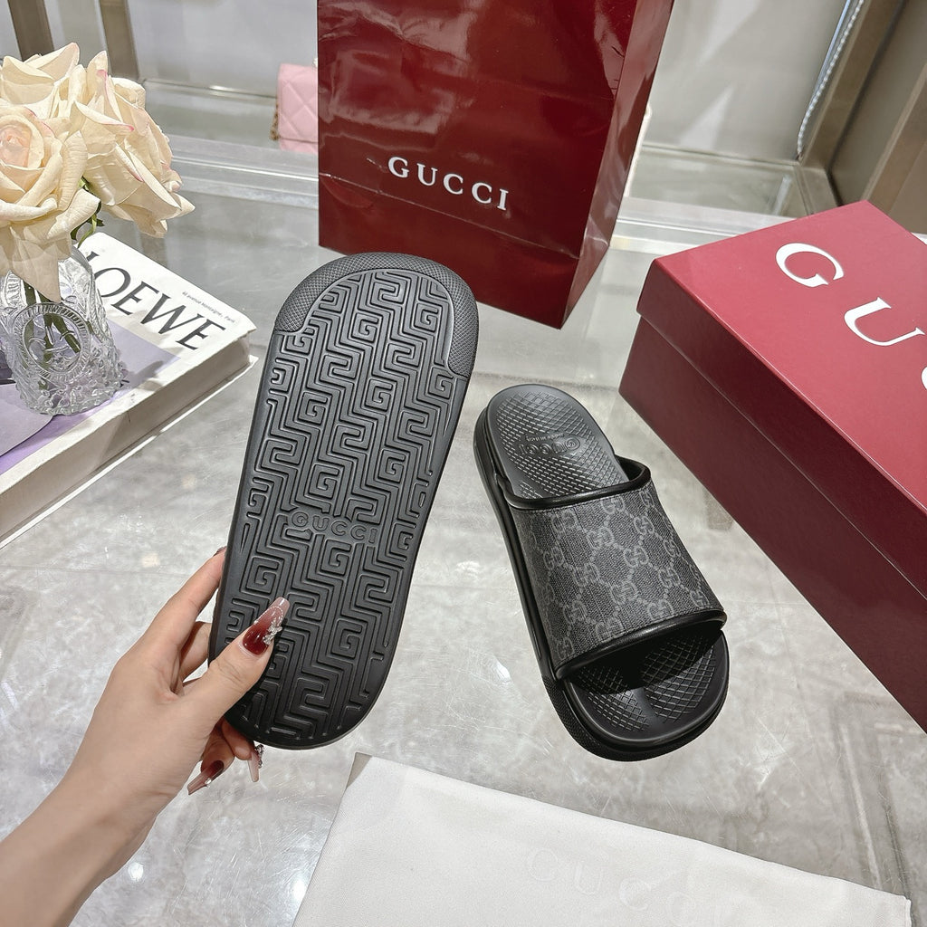 Monogram slide sandal with dark patterned outsole and dark GG-pattern upper, wide open strap