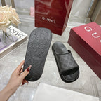 Monogram slide sandal with dark patterned outsole and dark GG-pattern upper, wide open strap