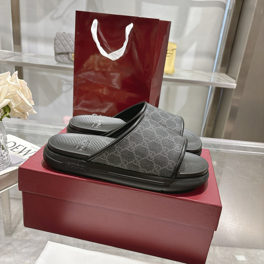 Monogram slide sandals in dark fabric with wide band strap and black textured footbeds