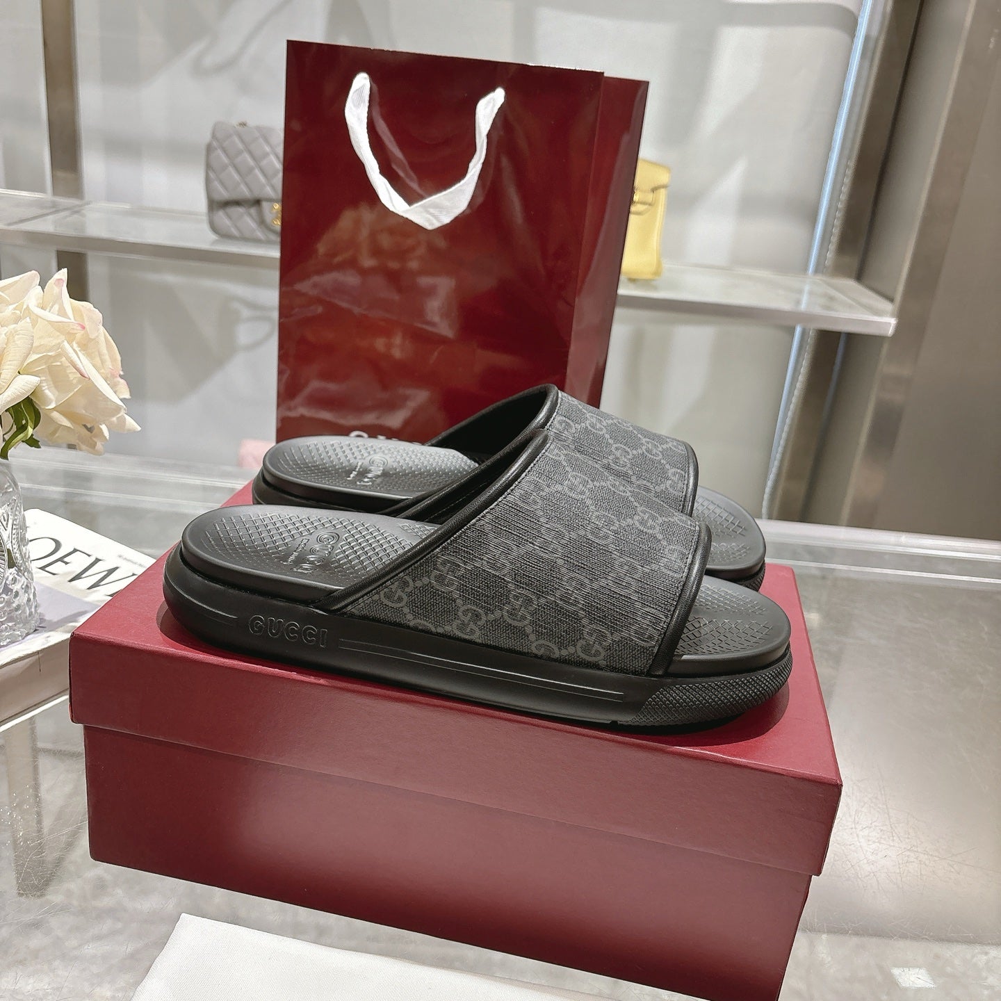 Monogram slide sandals in dark fabric with wide band strap and black textured footbeds