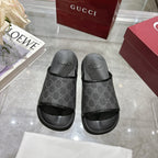 Monogram slide sandals with dark GG-pattern upper, open toe, and black rubber outsoles