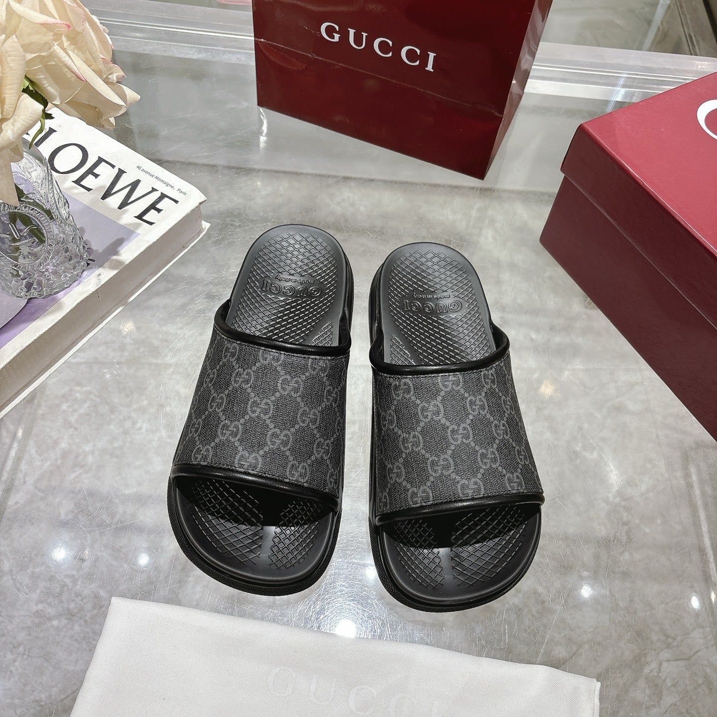 Monogram slide sandals with dark GG-pattern upper, open toe, and black rubber outsoles
