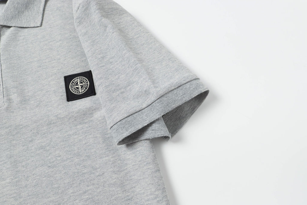 Light gray polo sleeve cuff with small logo patch