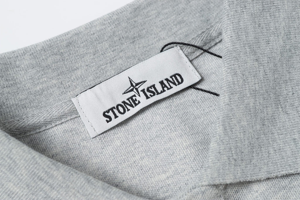 Light gray polo collar with woven logo label
