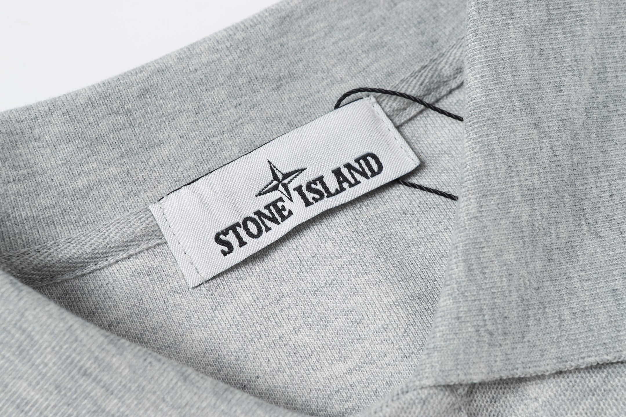 Light gray polo collar with woven logo label