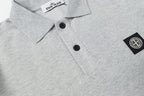 Light gray polo shirt front with black buttons and side logo patch