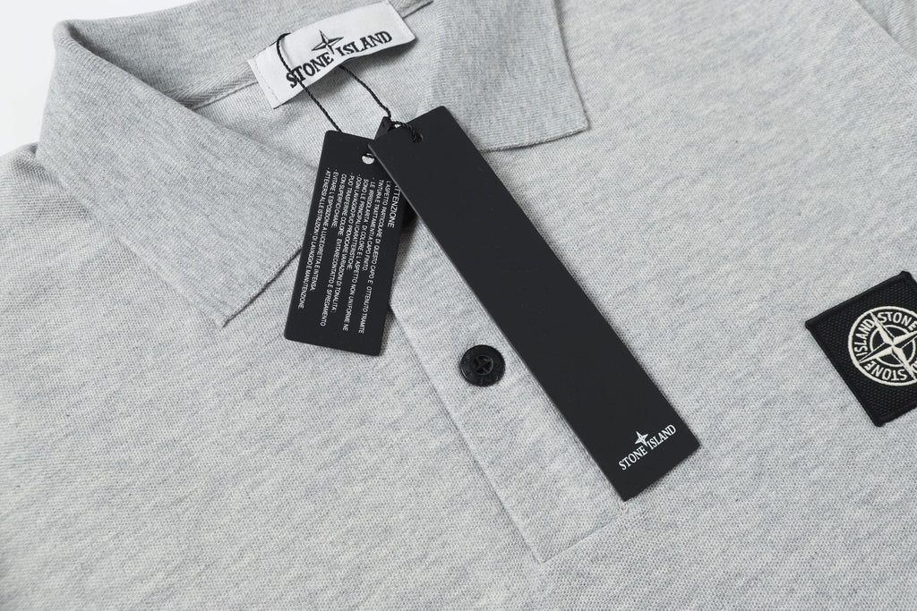 Light gray polo shirt collar and button placket with tag and logo patch