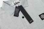 Light gray polo shirt collar and button placket with tag and logo patch