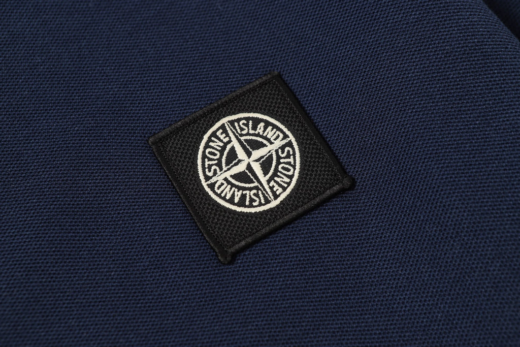 Navy woven logo patch with Stone Island text on polo fabric
