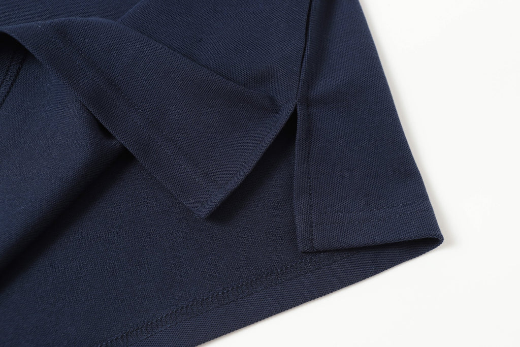 Navy polo shirt hem and sleeve cuff seam detail