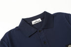 Navy polo shirt close-up showing spread collar and button placket