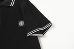 Black polo shirt sleeve with striped cuff and chest logo patch
