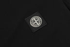 Stone Island circular logo patch on black polo fabric