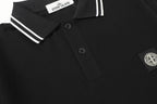 Black polo shirt with button placket and Stone Island shield patch