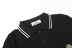 Black polo shirt with striped collar, button placket, and chest patch