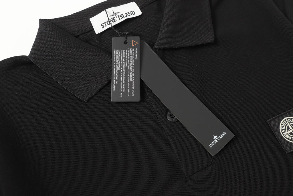 Black polo shirt collar with neck label and button placket
