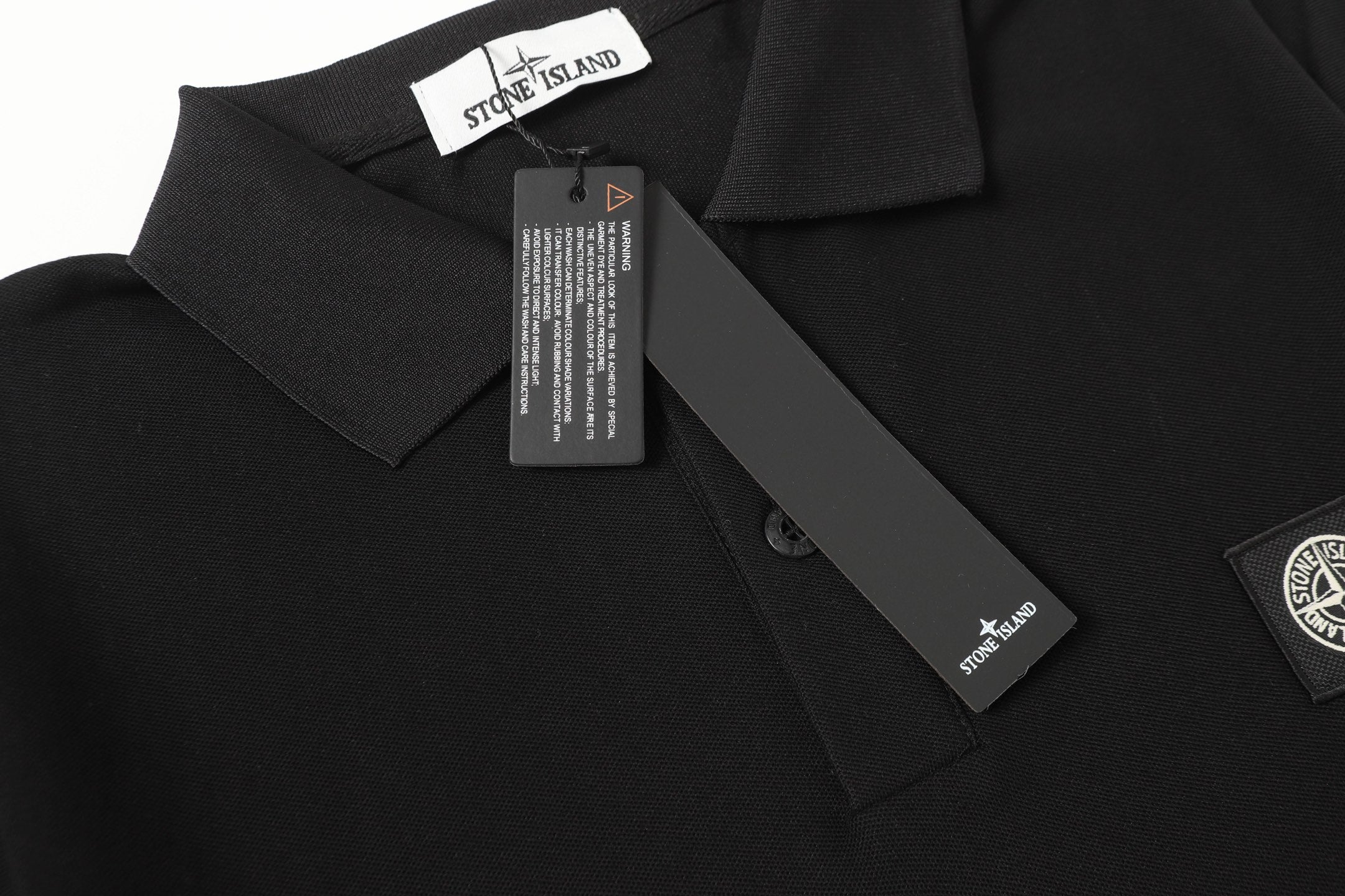 Black polo shirt collar with neck label and button placket