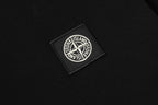 Stone Island logo patch on black textured fabric