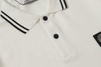 White polo shirt front with black buttons and partial sleeve stripe trim