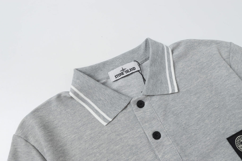 Light gray polo shirt neckline with two-button placket and striped collar