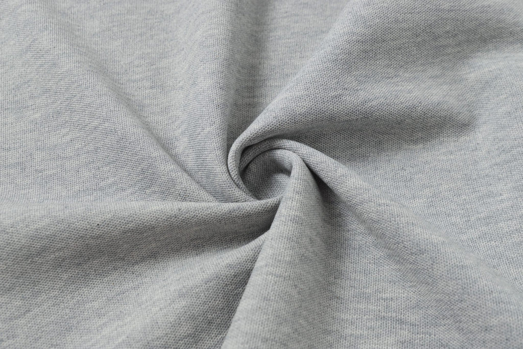 Light gray polo fabric close-up showing knit texture and drape