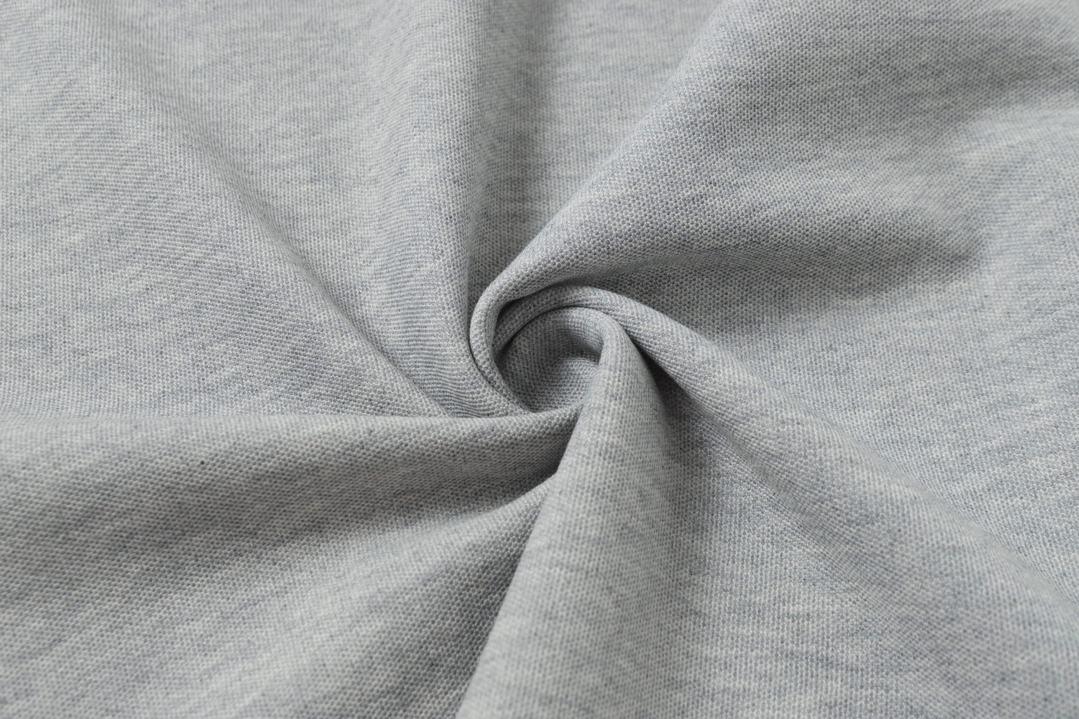 Light gray polo fabric close-up showing knit texture and drape