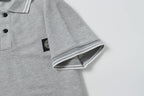 Light gray polo shirt sleeve cuff with striped ribbed trim