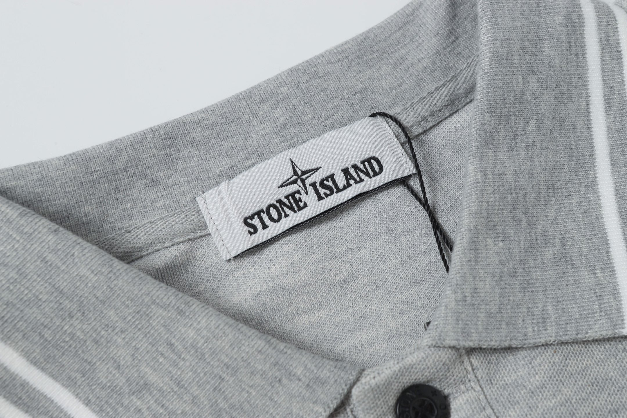 Light gray polo collar with Stone Island logo label